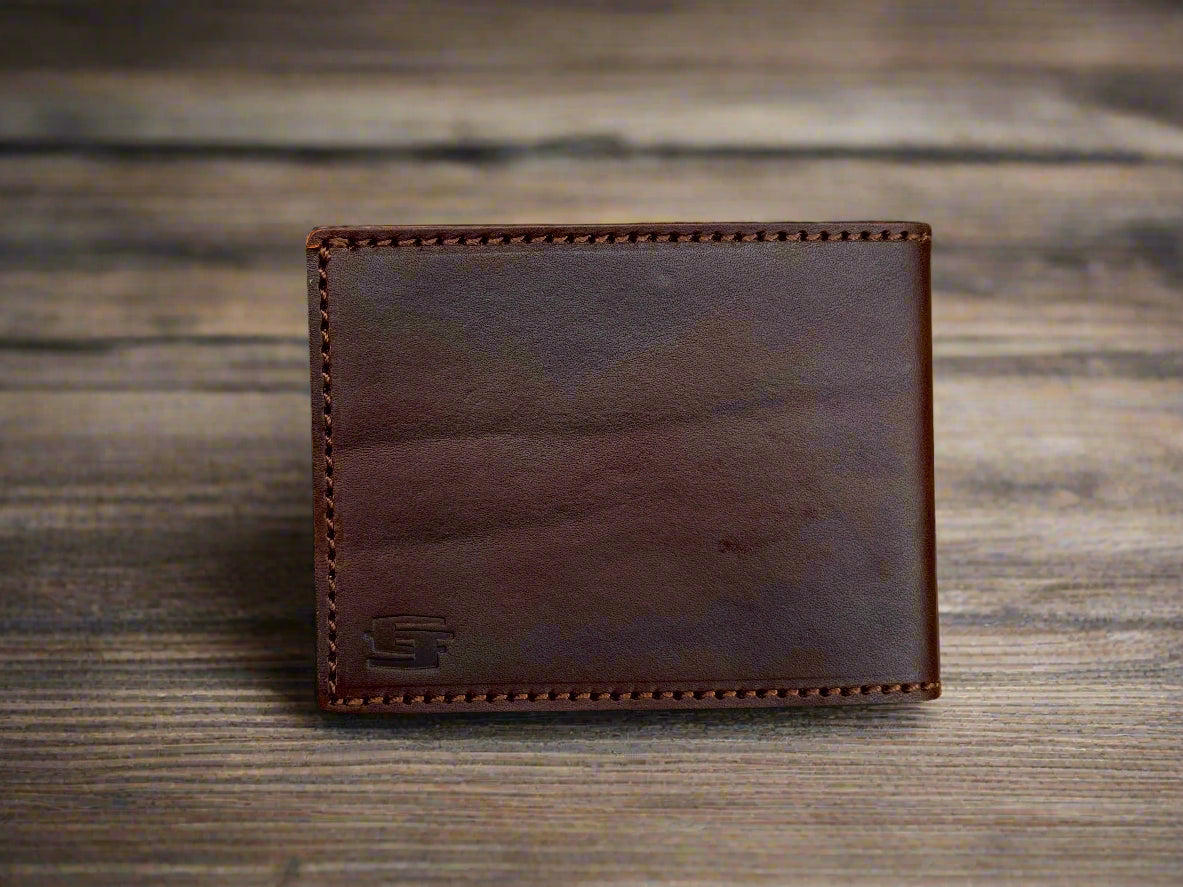 Dark Brown leather wallet on a wooden surface
