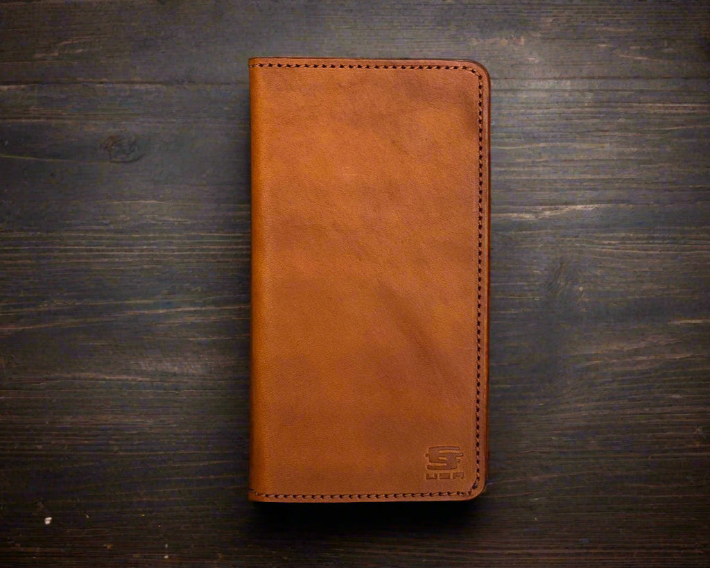 Brown leather phone case on a dark wooden surface