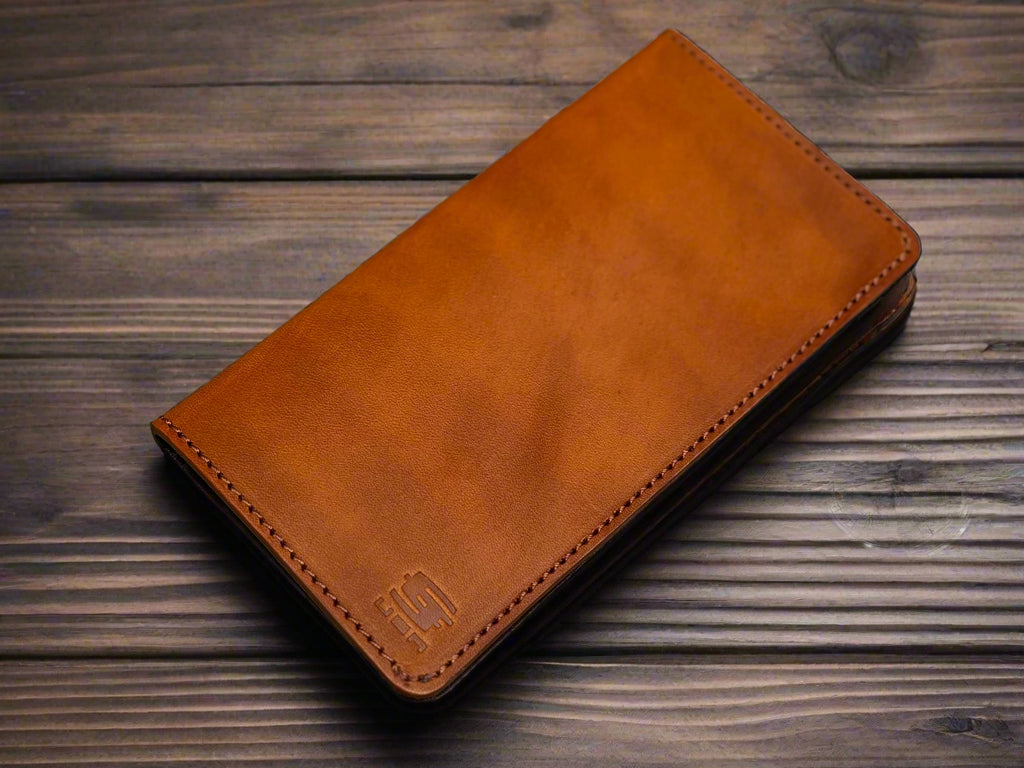 Brown leather wallet on a wooden surface