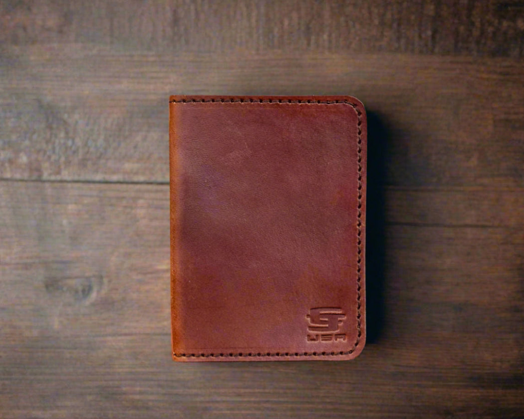 Brown leather wallet on a wooden surface