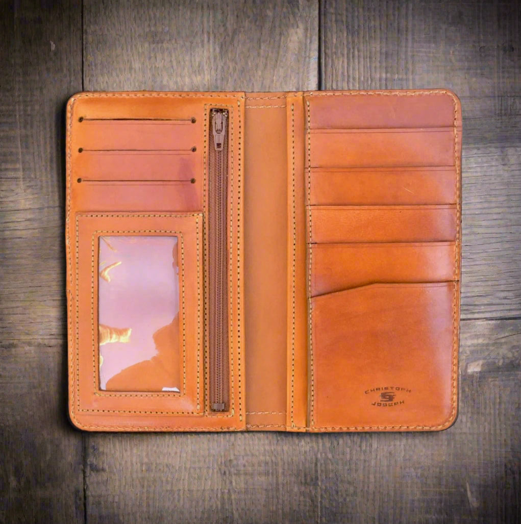 Brown leather wallet with multiple card slots and a zipper on a wooden surface
