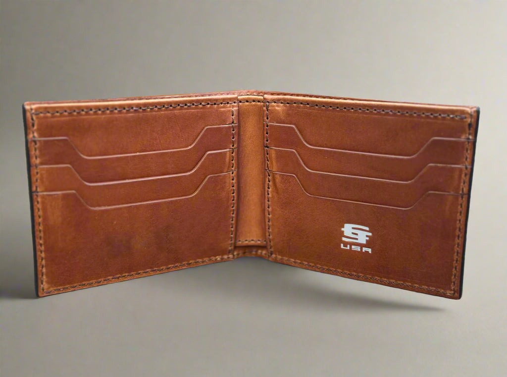 Brown leather wallet with visible brand logo on a wooden surface. Interior of Christoph Joseph Bourbon Bifold