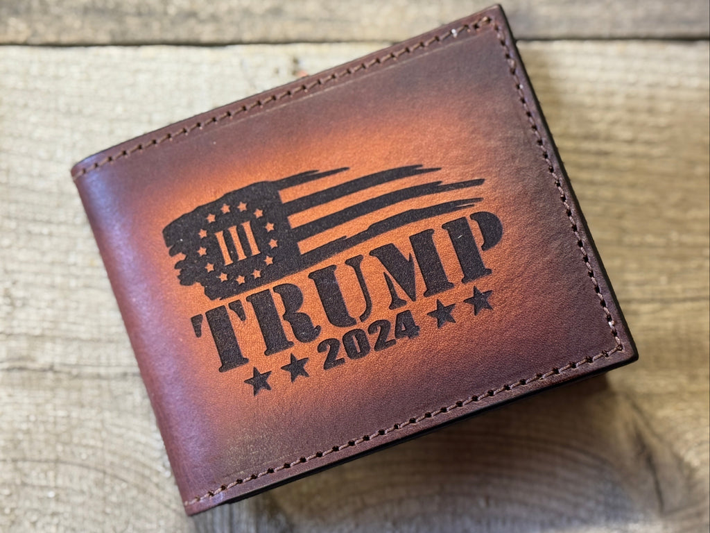Brown leather wallet with 'Trump 2024' engraving on a textured surface